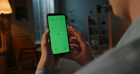 Close up shot of man holding a smartphone with chroma key mock up green screen - technology, connections, communications concept 