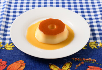 pudding on a white plate, a typical brazilian dessert