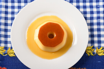 pudding on a white plate, a typical brazilian dessert