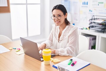 Young hispanic woman business worker using laptop working at office