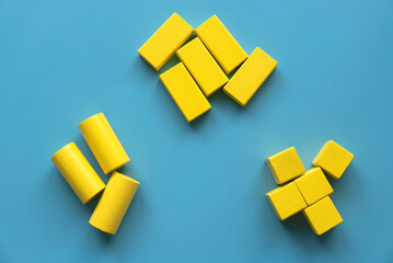 Category concept. Different shape of yellow wooden geometry block rearrange into its category.