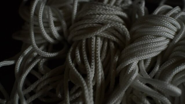 white bondage rope on a leather table. bdsm rope for bondage sex.