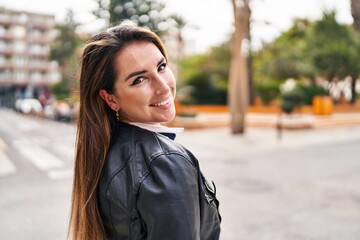 Young beautiful hispanic woman smiling confident standing at street