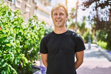 Young caucasian man smiling confident at street