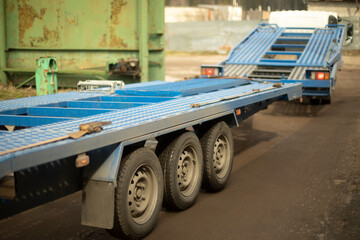 Pltatform for car towing. Freight transport. Blue trailer.