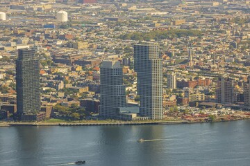 Fototapeta na wymiar Beautiful aerial view of buildings against backdrop of landscape of Hudson River in Manhattan. New York, USA.