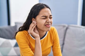 Young african american woman suffering for ear problem at home