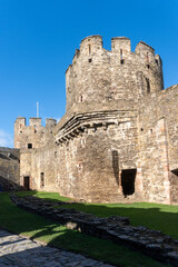 Fototapeta na wymiar Conwy, North Wales, United Kingdom: Conwy Castle fortification built by Edward I, during his conquest of Wales. Outer Ward, Site of Kitchen and Stables. Ancient stone walls and towers. 