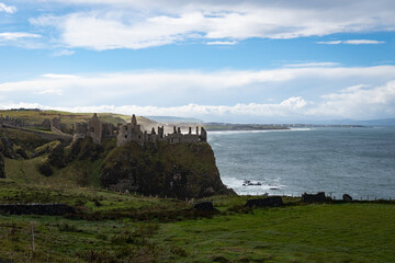Fototapeta na wymiar Dunluce Castle ruined medieval castle in Northern Ireland, seat of Clan MacDonnell. Dramatic setting on steep cliff to Irish Sea. Inhabited by both the feuding McQuillan and MacDonnell clans.