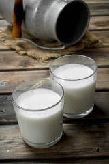Fresh milk in a glass with a can.