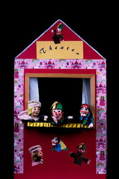 Kasperl, punch theater with hand puppets isolated on black background