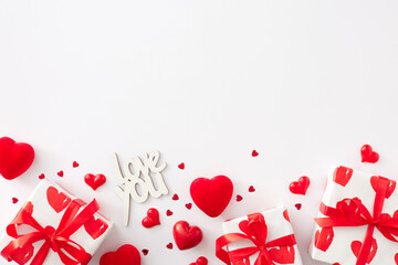 Valentines Day celebration concept. Flat lay photo of gift boxes with ribbon, red hearts and inscription love you on white background with copy space. Lovers holiday card idea.