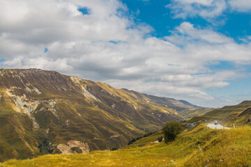 Snow-capped mountains and autumn fields. Beautiful mountain landscape in winter. Panoramic view, Dagestan, Russia.