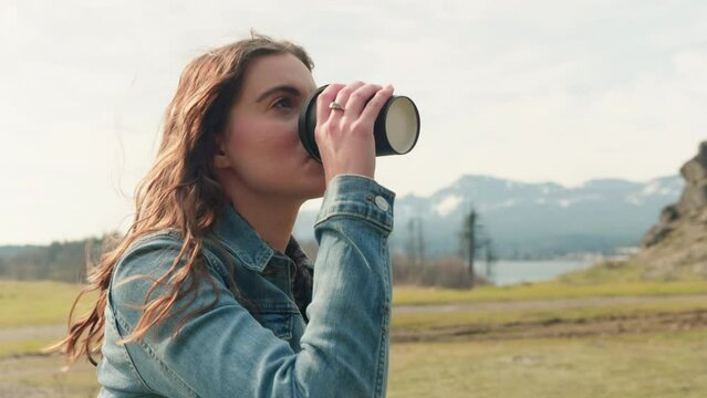 woman drinking coffee in the mountains tight 