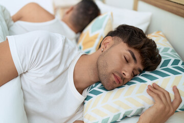 Two hispanic men couple lying on bed sleeping at bedroom