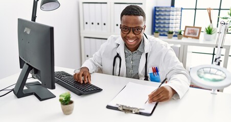 Young african man working as doctor at medical clinic