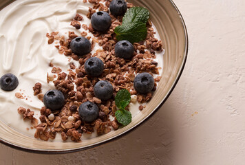 yogurt with chocolate muesli, with berries, blueberries, breakfast, close-up, fork on top, no people,