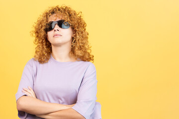 Rude woman with sunglasses standing with arms crossed