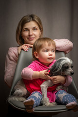 Fototapeta na wymiar Studio portrait of a young beautiful mother and little daughter.