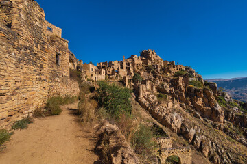Fototapeta premium ruins of house in the abandoned village of Gamsutl overlooking the mountains