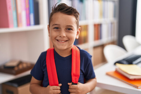 Adorable hispanic toddler student smiling confident standing at library school