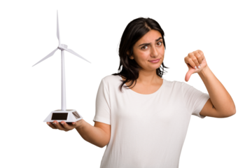 Young Indian woman holding a small wind energy mill isolated showing a dislike gesture, thumbs down. Disagreement concept.