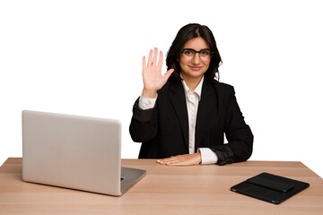 Young indian woman in a table with a laptop and tablet isolated smiling cheerful showing number five with fingers.