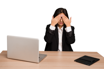 Young indian woman in a table with a laptop and tablet isolated afraid covering eyes with hands.
