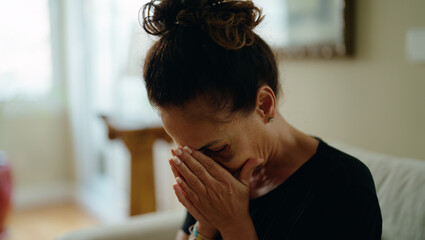 Middle age hispanic woman suffering for domestic violence with bruise on eyes crying at home