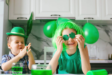 Two toddler boy and girl celebrate the holiday on March 17. Child celebrate St. Patrick's Day. Traditions, holidays concept.