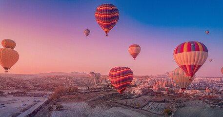 Romantic vacation Goreme national park, color hot air balloons fly, Amazing sunrise Cappadocia. Turkey travel Concept, aerial view - obrazy, fototapety, plakaty
