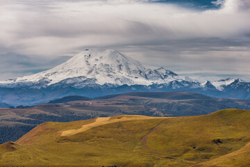 Fototapeta premium A view on Elbrus mountain and Malka river valley. Dzhili-Su, Republic of Kabardino-Balkaria