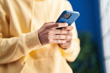 Young caucasian man using smartphone at home