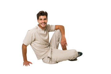 Young caucasian man sitting on the floor isolated on white background