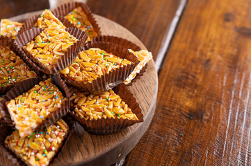 Desserts with almonds, peanuts and seeds in caramel. Traditional Sardinian sweet. Sweet squares....