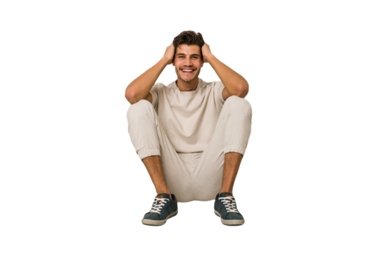 Young caucasian man sitting on the floor isolated on white background