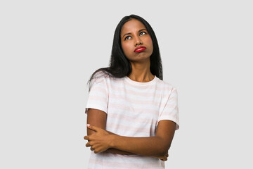 Fototapeta premium Young Indian woman cut out isolated on white background tired of a repetitive task.