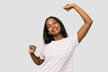 Young Indian woman cut out isolated on white background celebrating a special day, jumps and raise arms with energy.