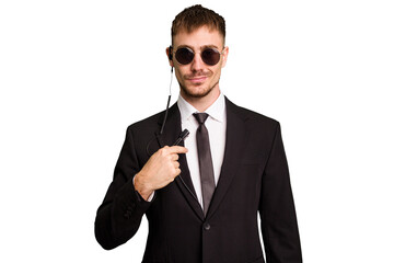 Security bodyguard man wearing a suit isolated cut out person pointing by hand to a shirt copy space, proud and confident