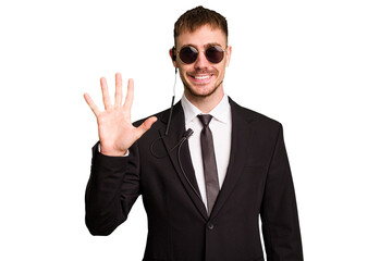 Security bodyguard man wearing a suit isolated cut out smiling cheerful showing number five with fingers.