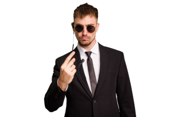 Security bodyguard man wearing a suit isolated cut out pointing with finger at you as if inviting come closer.