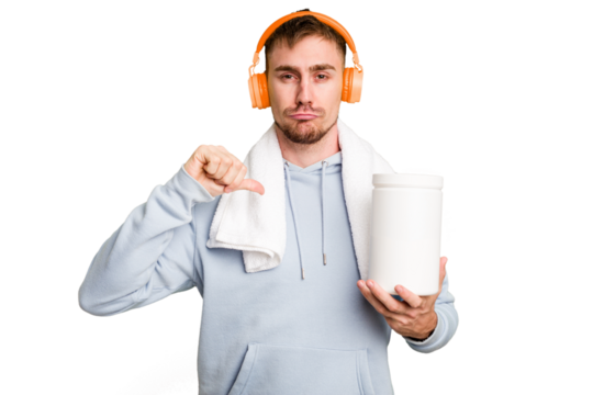 Young fitness man listening to music and holding a protein bottle isolated cut out feels proud and self confident, example to follow.