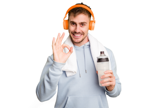 Young caucasian sporty man ready to start his gym day cheerful and confident showing ok gesture.