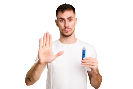 Young caucasian man holding a vaporizer cut out isolated standing with outstretched hand showing stop sign, preventing you.