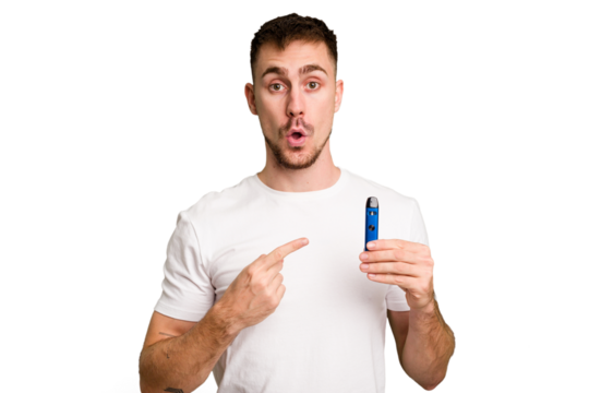 Young caucasian man holding a vaporizer cut out isolated pointing to the side