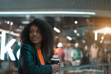 Young smiling african american girl walk in the mall  