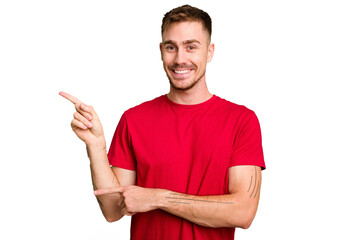 Young caucasian man cut out isolated excited pointing with forefingers away.