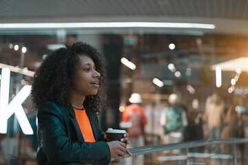 Young smiling african american girl walk in the mall  