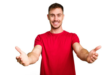 Young caucasian man cut out isolated showing a welcome expression.
