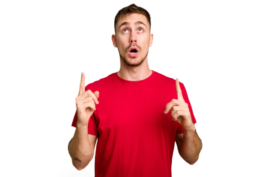 Young caucasian man cut out isolated pointing upside with opened mouth.